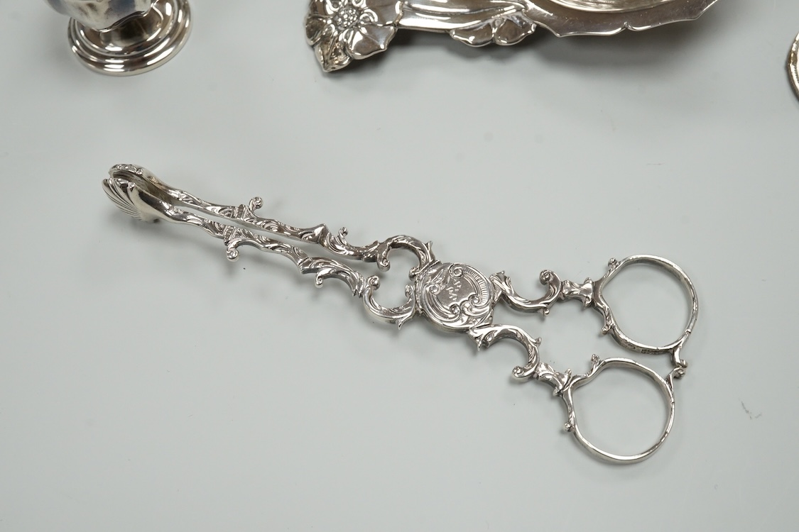 A late Victorian repousse silver navette shaped dish, by Charles Edwards, London, 1894, 25.7cm, with engraved monogram and date, together with a pair of mid 18th century silver sugar nips, an early 19th century silver vi
